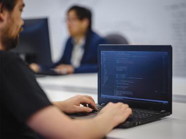 1ARPT-digital-journey Team member working on a computer