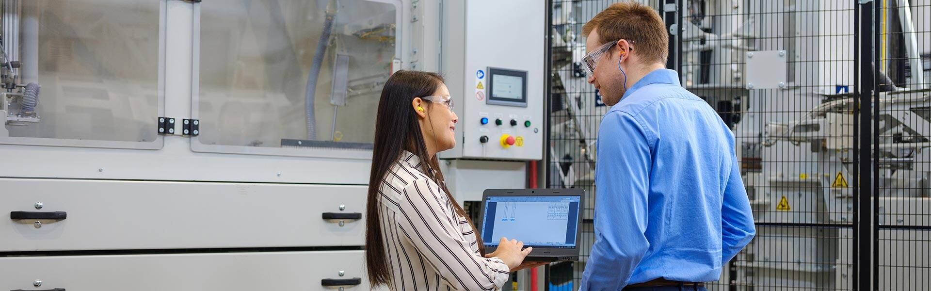 Team member talking near a production line